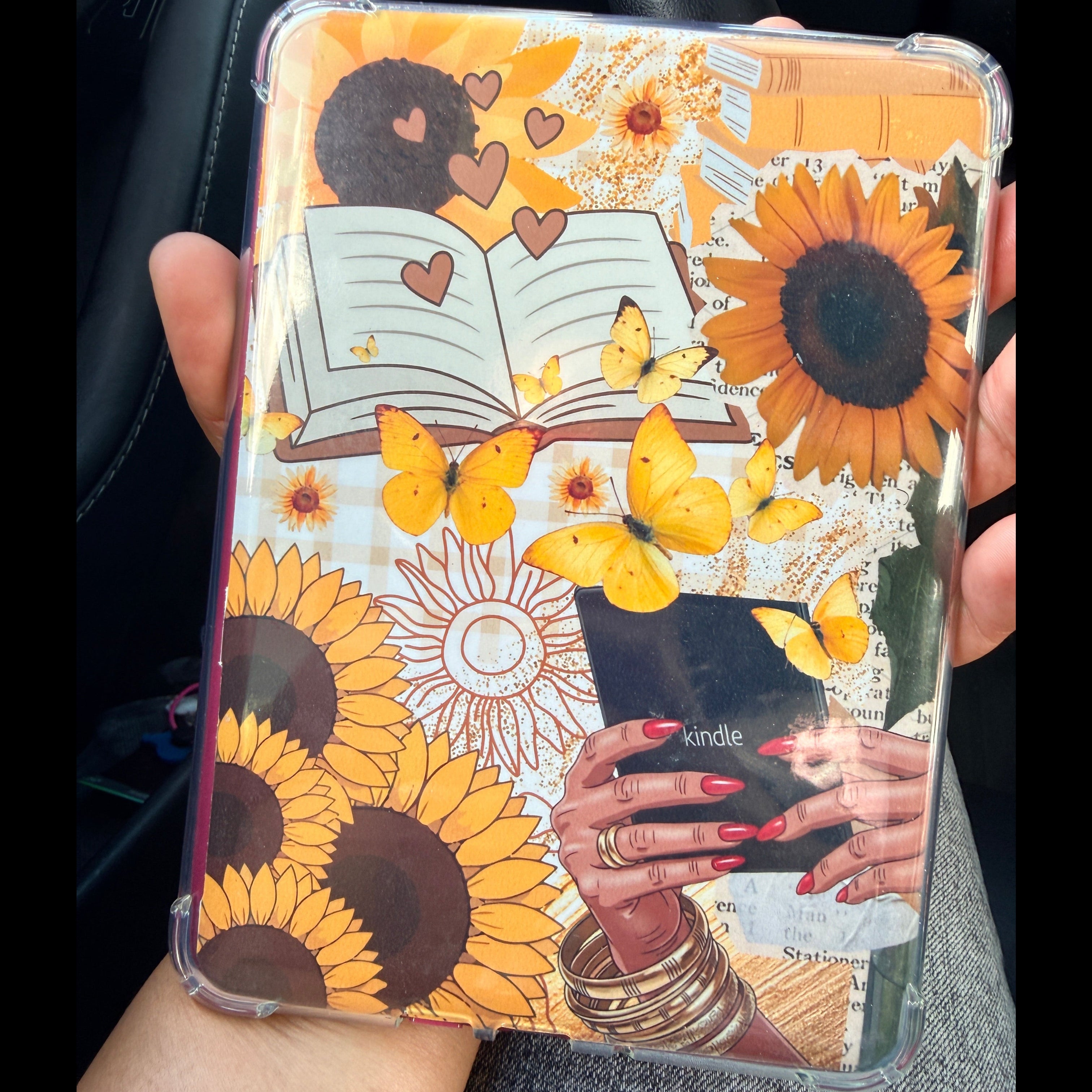 Decorative case with sunflower design held by a person