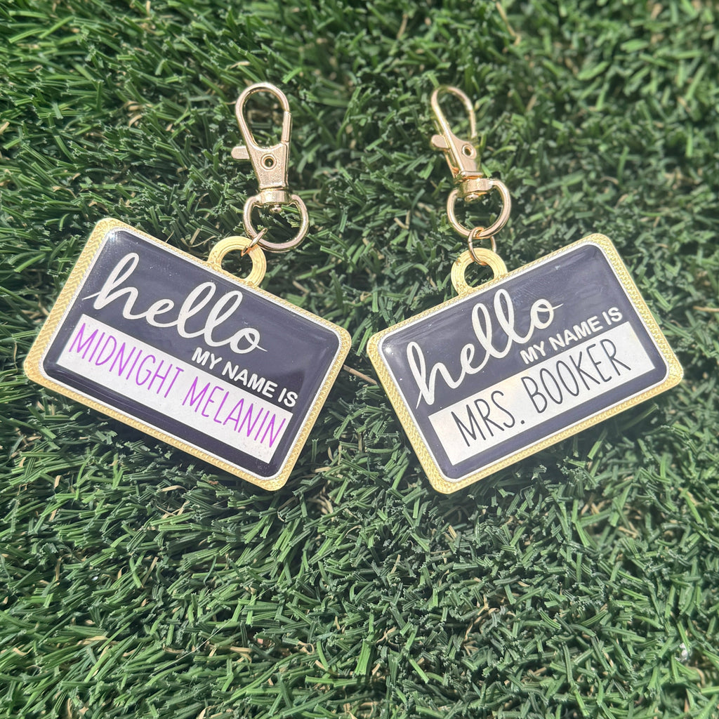 Two name tags with 'hello my name is' text on a grass background